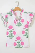 White blouse with vibrant pink and green floral embroidery featuring contrast scallop trim layered short sleeves and neckline