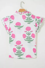White blouse with vibrant pink and green floral embroidery and a contrast scallop trim layered neckline