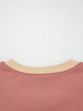 A soft rose-colored contrast star patchwork sweatshirt with ribbed beige crew neck and slightly stretchy fabric, machine wash cold