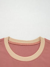A soft pink contrast star patchwork sweatshirt with a beige ribbed collar, slightly stretchy fabric, machine wash cold
