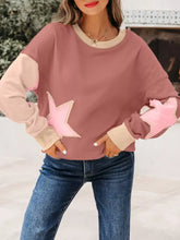 A soft pink and beige star patchwork sweatshirt with contrast color-block sleeves and slightly stretchy fabric machine wash cold