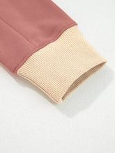 The sleeve cuff of a slightly stretchy contrast star patchwork sweatshirt in dusty rose and ribbed beige machine wash cold