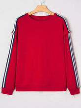 Red varsity sweatshirt with navy and white striped sleeves featuring contrast detail, machine wash cold recommended