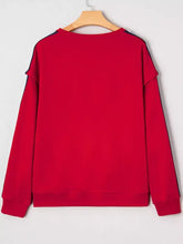 Red long-sleeved varsity sweatshirt with navy blue stripes designed for machine wash cold care
