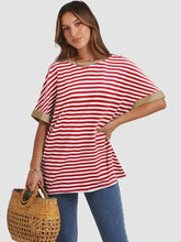 Woman in contrast striped round neck half sleeve t-shirt and jeans