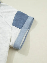 Contrast trim button detail top with heathered white fabric and denim blue patchwork sleeve with rolled cuffs
