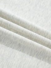 Soft heathered gray cotton contrast trim top with subtle texture and button detail for casual wear