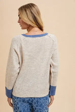 Cream cable knit raglan sleeve cardigan with contrast trim button and relaxed fit