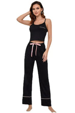 Black contrast trim cropped cami and pants loungewear set with pink ribbon tie white piping details and product measurements