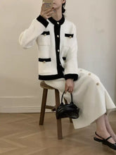 Black leather handbag with gold hardware in Contrast Trim Jacket and Skirts Sweater Set