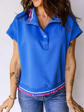 Bright blue short sleeve polo shirt with pink pom trim and white contrast details perfect for casual wear