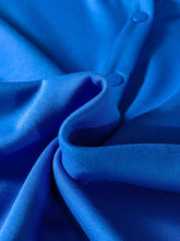 Vibrant royal blue satin short sleeve blouse with button closure and subtle pink pom trim detail