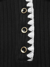 Black ribbed knit sweater dress with gold eyelets and white frayed trim