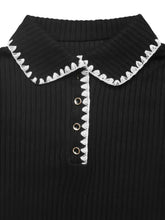 Black ribbed knit polo with white lace scalloped collar on sweater dress
