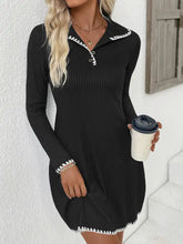 Black ribbed knit sweater dress with white scalloped trim on collar cuffs hem