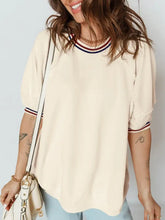 Cream-colored oversized tee with contrast varsity striped ribbed neckline and cuffed short sleeve details