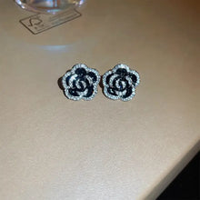 Pair of black and white camellia rhinestone flower earrings
