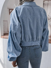 Blue corduroy cropped jacket with button-down front, patch pocket, and product measurements
