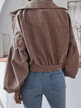 Brown corduroy cropped jacket with wide lapels, belt, pockets, and product measurements