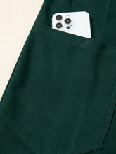 Dark green corduroy pocket with white smartphone, machine wash cold jumpsuit