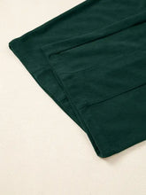 Dark green corduroy jumpsuit back with ribbed texture, seams, machine wash cold