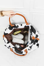Cow print plush weekender bag with brown leather handles
