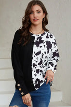 Women’s black and white animal print round neck long-sleeve top with button cuffs