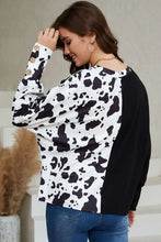 Women’s cow print round neck long sleeve top with button cuffs