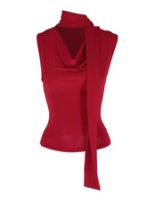 A vibrant red cowl neck ruched sleeveless cami with a high draped neckline and flowing fabric detail down the front