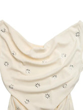 Cream-colored cowl neck sleeveless bodysuit with delicate silver star-shaped embellishments scattered across fabric