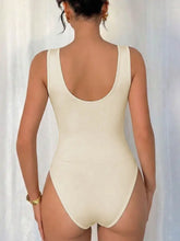 Cream-colored cowl neck sleeveless bodysuit with scoop neckline and high-cut legs in a form-fitting design