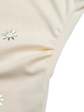 Cream-colored satin cowl neck sleeveless bodysuit with subtle circular silver embellishment detail