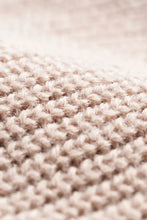 Close-up of fluffy beige knit in cozy rib-knit cuff beanie