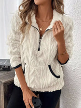 Cream-colored cozy sherpa half zip fleece jacket with textured fabric and black trim on zipper and cuffs in relaxed fit