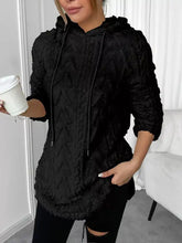 Black textured knit hoodie with ruffled hood and drawstrings made from slightly stretchy fleece, machine wash care instructions