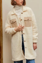 Cream and beige oversized faux fur teddy coat with high collar, buttons, and pockets