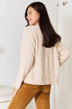 Cream boucle cropped cardigan with bell sleeve length and beige sweater
