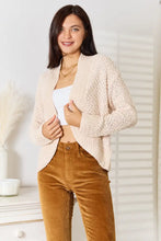 Cream boucle cropped cardigan with bell sleeve length and textured knit