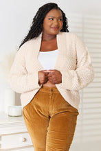 Cream boucle cropped cardigan with bell sleeve length and mustard corduroy pants
