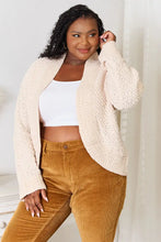 Cream boucle cropped cardigan with bell sleeve length and textured knit