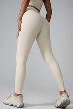 Person in cream high-waisted V-front athletic leggings and sports bra