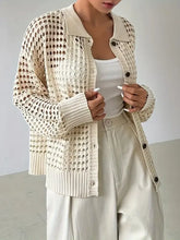 Cream knit button cardigan with heart cutout and textured pattern