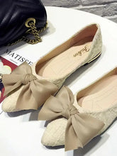 Cream point toe flats with beige quilted leather and large bow detail