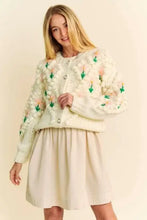 Cream skirt with Dani floral pattern, button closure, and cardigan features