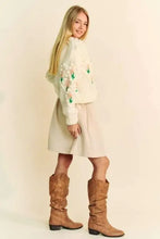 Beige knee-high boots with brown stitching, low heel, and Dani floral pattern cardigan features