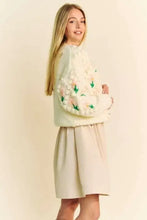 Pastel green sweater with Dani floral pattern, high neckline, and button closure