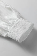 White textured fabric cuff with gathered ribbed design on a crinkled texture lantern sleeve button down loose shirt