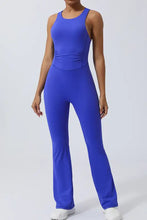 Royal blue racerback jumpsuit with flared legs, crisscross straps, bust, waist fit
