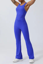 Royal blue Crisscross Wide Strap Jumpsuit with tattooed arm, white sneakers