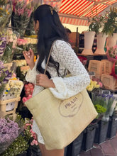 Beige Prada tote bag with woven texture and embroidered logo